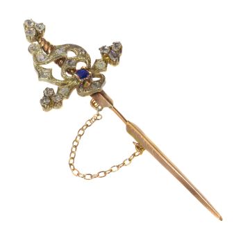 Vintage pin in the form of a sword set with diamonds and a sapphire by Artista Desconocido
