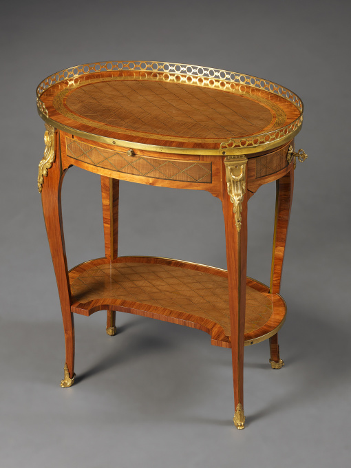 A French Transitional Small Oval Writing Table by Nicolas Petit