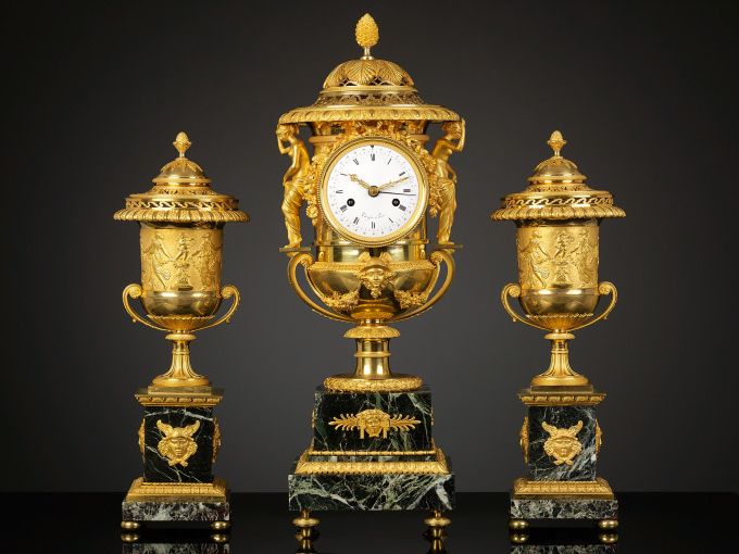An Empire Suite of an Urn-shaped Mantel Clock and Two Vases by Pierre-Philippe Thomire