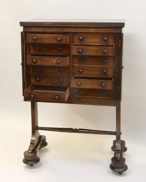 A Regency rosewood collectors cabinet on separate base. by Artista Sconosciuto